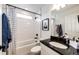 This bathroom features a shower, tiled walls, and a vanity with dark granite countertops at 4443 N Quatar Ct, Aurora, CO 80019