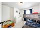 This bedroom includes bunkbeds, natural light, and a dresser at 4443 N Quatar Ct, Aurora, CO 80019