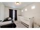 This second bedroom offers both a twin bed and a crib at 4443 N Quatar Ct, Aurora, CO 80019