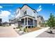 An appealing two-story home with white siding and stone accents, featuring a welcoming entryway and landscaped surroundings at 4443 N Quatar Ct, Aurora, CO 80019