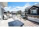 Relaxing front porch view with seating and a table, showcasing a well-maintained neighborhood with varied home exteriors at 4443 N Quatar Ct, Aurora, CO 80019