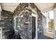 An attractive porch with stone accents and a black front door at 4443 N Quatar Ct, Aurora, CO 80019