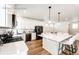Modern kitchen with white cabinets, stainless steel appliances, and a large center island with bar stool seating at 4443 N Quatar Ct, Aurora, CO 80019