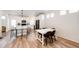 Open kitchen with stainless steel appliances, white countertops, an island, and a dining space with natural light at 4443 N Quatar Ct, Aurora, CO 80019