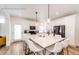 Modern kitchen featuring white cabinets, a large kitchen island, stainless steel appliances and wood floors at 4443 N Quatar Ct, Aurora, CO 80019