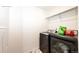 The laundry room offers modern appliances and tile flooring at 4443 N Quatar Ct, Aurora, CO 80019