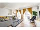Bright living room with a gray sectional sofa, a rocking chair, and sliding doors leading to a balcony at 4443 N Quatar Ct, Aurora, CO 80019