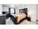 This main bedroom features a spacious layout with carpet floors and elegant dark furniture at 4443 N Quatar Ct, Aurora, CO 80019