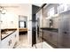 This Primary shower offers sleek tiling, a glass door, and dual vanities at 4443 N Quatar Ct, Aurora, CO 80019