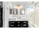 Modern bathroom with double sink vanity, sleek fixtures, and glass enclosed shower at 9756 E 113Th Ave, Commerce City, CO 80640