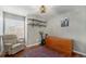 Bedroom features hardwood floors, large window, and a dresser at 9756 E 113Th Ave, Commerce City, CO 80640