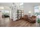 Inviting living room showcasing an open layout, wood flooring, and an abundance of natural light from the large windows at 9756 E 113Th Ave, Commerce City, CO 80640