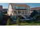 View of the back exterior featuring a large deck and covered patio area with outdoor seating at 8761 S Wenatchee Ct, Aurora, CO 80016