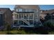 Expansive backyard featuring a covered deck, outdoor seating, and well-maintained landscaping at 8761 S Wenatchee Ct, Aurora, CO 80016