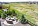 Relaxing backyard view featuring a fire pit with seating, lush greenery and a private fence at 8761 S Wenatchee Ct, Aurora, CO 80016