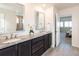 Bathroom features a double sink vanity with granite countertops, decorative accents, and tile flooring at 8761 S Wenatchee Ct, Aurora, CO 80016