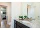 Bright bathroom with dual sinks and granite countertops showing views into adjacent rooms at 8761 S Wenatchee Ct, Aurora, CO 80016
