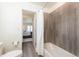 Bathroom showcasing a tub with tile surround and an attached ensuite bathroom, offering comfort and convenience at 8761 S Wenatchee Ct, Aurora, CO 80016
