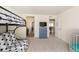 Well-lit bedroom features a bunk bed, sleeper sofa, and blue dresser, creating a versatile and playful space at 8761 S Wenatchee Ct, Aurora, CO 80016