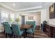 Dining room featuring a stylish table, seating for four, and a modern wine cooler at 8761 S Wenatchee Ct, Aurora, CO 80016