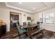 Dining room with a rustic wooden table, seating for six, and a modern wine cooler at 8761 S Wenatchee Ct, Aurora, CO 80016