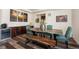 Dining room with a rustic wooden table, seating for six, and a modern wine cooler at 8761 S Wenatchee Ct, Aurora, CO 80016