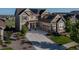 Beautiful home exterior with solar panels, manicured lawn and long driveway at 8761 S Wenatchee Ct, Aurora, CO 80016
