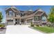 Charming home exterior featuring a three-car garage, stone accents, and well-kept landscaping at 8761 S Wenatchee Ct, Aurora, CO 80016