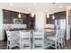 Spacious kitchen with a large island, stainless steel appliances, and stylish pendant lighting at 8761 S Wenatchee Ct, Aurora, CO 80016