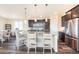 The kitchen features stainless steel appliances, granite countertops, a center island, and stylish pendant lighting at 8761 S Wenatchee Ct, Aurora, CO 80016