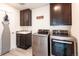 Convenient laundry room featuring modern appliances, built-in storage, and a practical layout at 8761 S Wenatchee Ct, Aurora, CO 80016