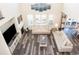 Bright living room with large windows, comfortable seating, and a fireplace at 8761 S Wenatchee Ct, Aurora, CO 80016