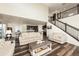 Bright living room features hardwood floors, neutral decor, and staircase to the upper level at 8761 S Wenatchee Ct, Aurora, CO 80016