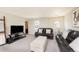 Relaxing living room with plush seating, a modern entertainment center, and cozy ambiance at 8761 S Wenatchee Ct, Aurora, CO 80016