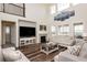 Cozy living room with a fireplace, plush seating, and modern decor at 8761 S Wenatchee Ct, Aurora, CO 80016