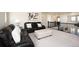 Inviting loft featuring comfortable leather seating, stylish accents, and a view of the lower level, perfect for lounging at 8761 S Wenatchee Ct, Aurora, CO 80016