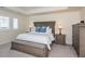 Main bedroom with wood furnishings, a large bed and ample natural light from the windows at 8761 S Wenatchee Ct, Aurora, CO 80016