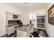 Well-lit home office featuring custom desk and ample storage space at 8761 S Wenatchee Ct, Aurora, CO 80016