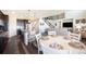 Open concept layout includes kitchen, dining area, living room with staircase and hardwood floors at 8761 S Wenatchee Ct, Aurora, CO 80016