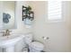 Stylishly decorated powder room with elegant fixtures and natural light at 8761 S Wenatchee Ct, Aurora, CO 80016