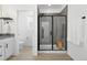 Modern bathroom featuring a glass shower with hexagon tile and a stylish vanity at 12261 Farmview St, Thornton, CO 80241