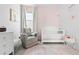 Charming Bedroom with a white crib, soft colors, and decorative accents at 12261 Farmview St, Thornton, CO 80241