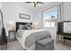 Cozy bedroom featuring a comfortable bed, soft lighting, and a view from the window at 12261 Farmview St, Thornton, CO 80241