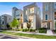 Modern three-story home featuring sleek architecture, and a well-maintained front yard at 12261 Farmview St, Thornton, CO 80241