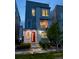 A modern two-story home, featuring a vibrant red front door and a well-manicured lawn at 12261 Farmview St, Thornton, CO 80241