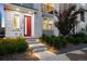 Modern home entrance with a vibrant red door and landscaped walkway with lighting at 12261 Farmview St, Thornton, CO 80241