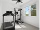 Home gym featuring a treadmill, INSPIRE weight machine, and natural light at 12261 Farmview St, Thornton, CO 80241