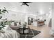 Bright open-concept living room with modern kitchen, stylish furnishings, and lots of natural light at 12261 Farmview St, Thornton, CO 80241
