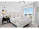 Airy main bedroom featuring a large window, neutral tones, and cozy decor at 12261 Farmview St, Thornton, CO 80241
