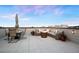 Stylish rooftop deck with a fire pit, comfortable seating, and an outdoor dining area for enjoying sunset views at 12261 Farmview St, Thornton, CO 80241